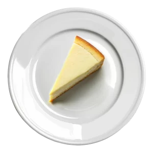 L'image montre une tranche de cheesecake sur une assiette blanche.